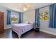 Cozy bedroom bathed in natural light with two large windows and neutral decor at 768 Pinellas Point S Dr, St Petersburg, FL 33705