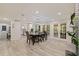 Bright dining room with fireplace, french doors, and open-concept layout into the kitchen at 768 Pinellas Point S Dr, St Petersburg, FL 33705