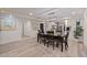 Open-concept dining area leading to kitchen, features wood floors, and bright, neutral decor at 768 Pinellas Point S Dr, St Petersburg, FL 33705