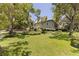 Charming two-story home featuring lush landscaping and a large, well-maintained lawn at 768 Pinellas Point S Dr, St Petersburg, FL 33705