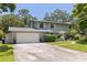 Inviting two-story home with a well-manicured lawn and attached two-car garage at 768 Pinellas Point S Dr, St Petersburg, FL 33705