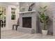Living room fireplace and mantle with light gray painted brick and light gray tile flooring at 768 Pinellas Point S Dr, St Petersburg, FL 33705