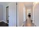 Hallway featuring a view into the bedroom, bathroom, and a large closet with hardwood floors and light-colored walls at 768 Pinellas Point S Dr, St Petersburg, FL 33705