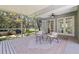 Enjoy the outdoors in this screened-in lanai with a neutral rug and views of the backyard's mature landscaping at 768 Pinellas Point S Dr, St Petersburg, FL 33705