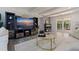 Cozy living room with entertainment center and brick accent wall with a clear view to the backyard at 768 Pinellas Point S Dr, St Petersburg, FL 33705