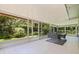 Enjoy the outdoors in this enclosed patio with a table, chairs, and stunning greenery at 768 Pinellas Point S Dr, St Petersburg, FL 33705