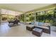 Relaxing screened-in patio featuring comfortable seating with a view of the lush landscaping at 768 Pinellas Point S Dr, St Petersburg, FL 33705