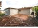 Exterior of home showing backyard with a brick patio and white walls at 7904 Judith Cres, Port Richey, FL 34668