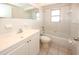 A bright bathroom featuring tile floors, a vanity sink, toilet, and a shower-tub combination at 7904 Judith Cres, Port Richey, FL 34668