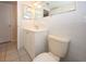 Bathroom with white tile, white vanity and toilet at 7904 Judith Cres, Port Richey, FL 34668