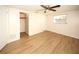 Bedroom with hardwood flooring, a ceiling fan, a closet with sliding doors, and natural light at 7904 Judith Cres, Port Richey, FL 34668