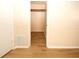 A bedroom closet featuring laminate flooring and a single rod for organized storage at 7904 Judith Cres, Port Richey, FL 34668