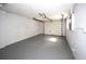 Spacious garage with gray painted floor and white walls at 7904 Judith Cres, Port Richey, FL 34668