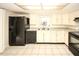 Well-lit kitchen with black appliances, light countertops, and a classic tiled floor at 7904 Judith Cres, Port Richey, FL 34668