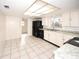 Bright kitchen with updated appliances, white cabinets, tiled floor, and ample countertop space at 7904 Judith Cres, Port Richey, FL 34668