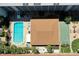 Aerial view showcasing the pool, shuffleboard court, and layout of the condo complex at 801 83Rd N Ave # 209, St Petersburg, FL 33702