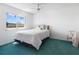 Bright bedroom featuring a large window, ceiling fan, and minimalist decor at 801 83Rd N Ave # 209, St Petersburg, FL 33702