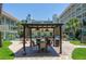 Picturesque courtyard featuring comfortable seating, a grill, and lush landscaping at 801 83Rd N Ave # 209, St Petersburg, FL 33702