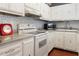 Well-equipped kitchen with white cabinets, appliances, and ample counter space at 801 83Rd N Ave # 209, St Petersburg, FL 33702