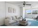 Bright living room with ample seating, ceiling fan, and large window at 801 83Rd N Ave # 209, St Petersburg, FL 33702