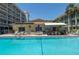 Relaxing pool area with comfortable seating, shade, and inviting blue water at 801 83Rd N Ave # 209, St Petersburg, FL 33702
