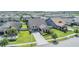Aerial view of a home in a well-planned community with lush greenery, sidewalks, and neighborhood charm at 8296 Olive Brook Dr, Wesley Chapel, FL 33545