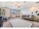 Spacious bonus room featuring neutral carpet, large window, and cozy furnishings, perfect for a home office or lounge area at 8296 Olive Brook Dr, Wesley Chapel, FL 33545
