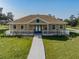 Charming community clubhouse with a welcoming front porch and well-maintained landscaping adds curb appeal at 8296 Olive Brook Dr, Wesley Chapel, FL 33545