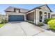 Single story home with a two car garage, large driveway and a covered front porch at 8296 Olive Brook Dr, Wesley Chapel, FL 33545