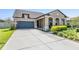 Charming single-story home featuring a well-manicured lawn and a two-car garage, creating a welcoming curb appeal at 8296 Olive Brook Dr, Wesley Chapel, FL 33545