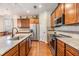 Modern kitchen featuring granite countertops, stainless steel appliances, and sleek wood cabinetry at 8296 Olive Brook Dr, Wesley Chapel, FL 33545
