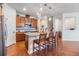 A centrally-located kitchen features granite countertops, wood cabinets and stainless steel appliances at 8296 Olive Brook Dr, Wesley Chapel, FL 33545
