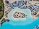 Overhead view of the lagoon's white sand beach with tiki huts and rows of lounge chairs at 8296 Olive Brook Dr, Wesley Chapel, FL 33545