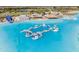 Beautiful aerial view of a lagoon with an inflatable obstacle course and white sand beaches at 8296 Olive Brook Dr, Wesley Chapel, FL 33545