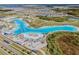 Aerial shot of a lagoon surrounded by lush greenery and a residential community at 8296 Olive Brook Dr, Wesley Chapel, FL 33545