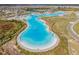 Expansive aerial view of the lagoon showcasing its size, shape, and community features at 8296 Olive Brook Dr, Wesley Chapel, FL 33545