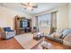 Bright living room with hardwood floors, large built-in entertainment center, and large windows for lots of light at 8296 Olive Brook Dr, Wesley Chapel, FL 33545