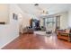 This living room has beautiful wood floors, lots of seating, and large windows letting in plenty of natural light at 8296 Olive Brook Dr, Wesley Chapel, FL 33545