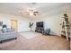 Large living room with plush carpeting and bright interior, providing ample space for relaxation and entertaining guests at 8296 Olive Brook Dr, Wesley Chapel, FL 33545