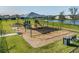 Community playground featuring swings and play areas with a water view, great for neighborhood families at 8296 Olive Brook Dr, Wesley Chapel, FL 33545