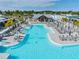 Expansive community pool area with ample seating, umbrellas, and beautifully landscaped surroundings at 8296 Olive Brook Dr, Wesley Chapel, FL 33545