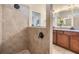 Elegant tiled walk-in shower with rainfall showerhead and partial view of vanity at 8296 Olive Brook Dr, Wesley Chapel, FL 33545