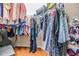 Spacious walk-in closet with hanging clothes, shelving for shoes, and laminate flooring at 8296 Olive Brook Dr, Wesley Chapel, FL 33545