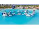 The water park features an inflatable obstacle course, slides, and a sandy beach at 8296 Olive Brook Dr, Wesley Chapel, FL 33545