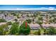 Wide aerial shot of the property set among a neighborhood with nearby commercial buildings at 8576 Sandy Beach St, Tampa, FL 33634