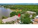 Aerial shot showcasing a lakefront property with well-manicured lawns and mature trees enhancing curb appeal at 8576 Sandy Beach St, Tampa, FL 33634