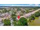 Aerial view of the property surrounded by mature trees, water, and other homes at 8576 Sandy Beach St, Tampa, FL 33634