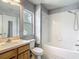 Bright bathroom featuring a shower-tub combo and a single-sink vanity with natural lighting at 8576 Sandy Beach St, Tampa, FL 33634