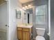 Bathroom with a window and wooden cabinets at 8576 Sandy Beach St, Tampa, FL 33634