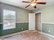 Bedroom with window, ceiling fan, and view to the neighborhood at 8576 Sandy Beach St, Tampa, FL 33634